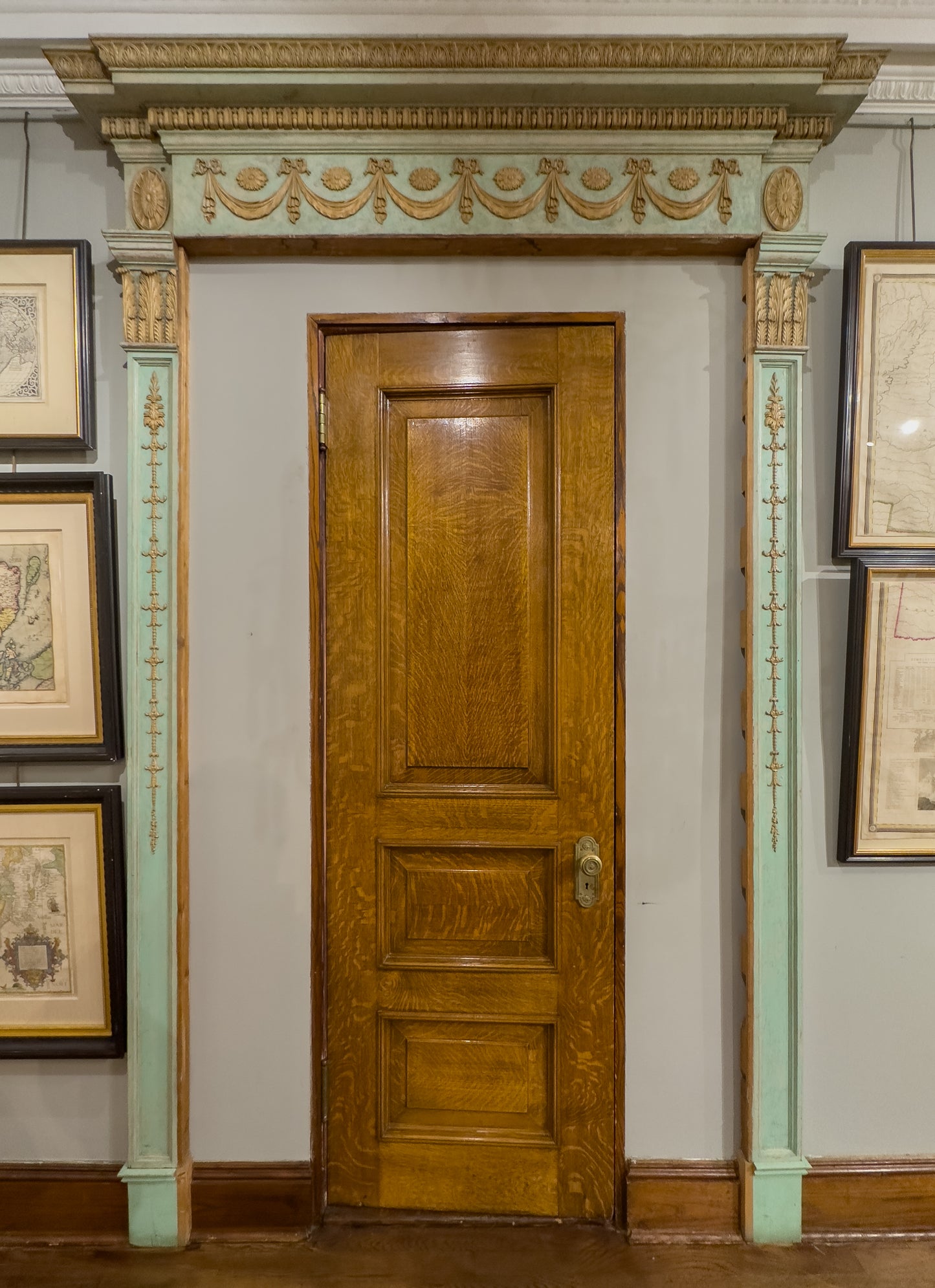 A George III gessoed-and-painted pine door-surround. Attributed to James Wyatt, commissioned by William Brummell for Donnington Grove, Berkshire. Ca. 1782.